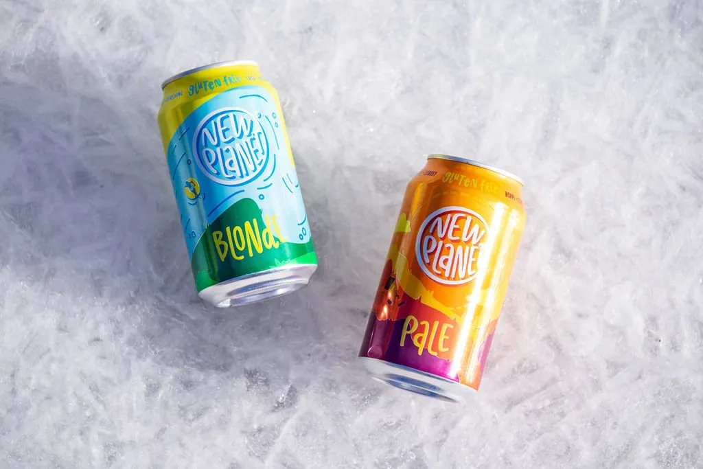 New Planet Blonde and Pale cans lying on snow
