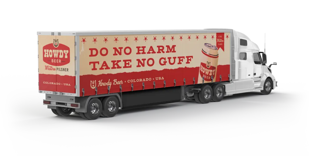 Semi truck trailer wrapped with 'Do No Harm, Take No Guff' Howdy graphics