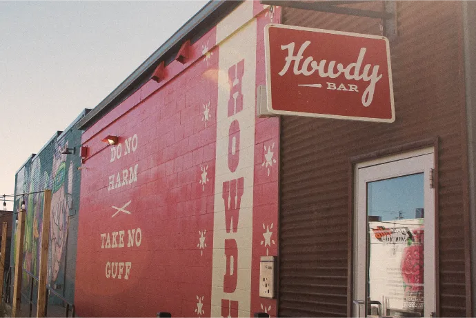 Howdy Bar exterior mural in red and cream