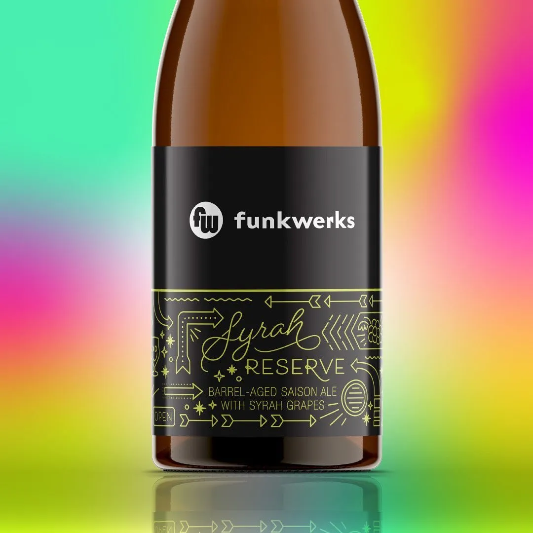 Syrah Reserve bottle with gold-foil label on a rainbow gradient background